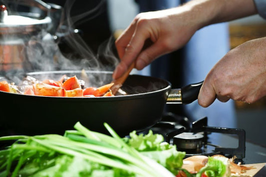 A person cooking food in a pan